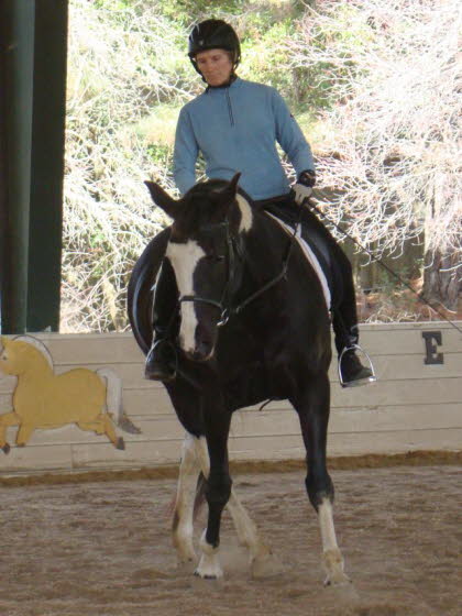 Under the watchful Paint eyes, Liz rides their buddy Fling, a champion barrel racer